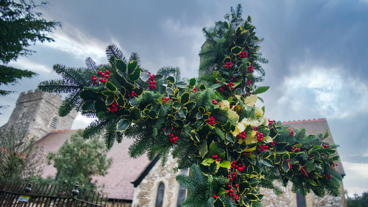 Cross with holly decoration